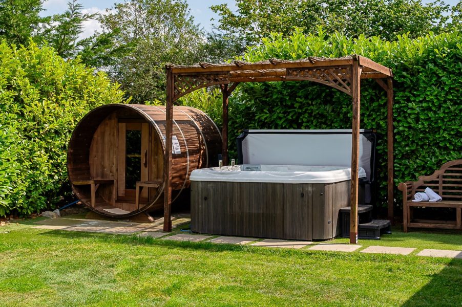 log cabin with hot tub and sauna