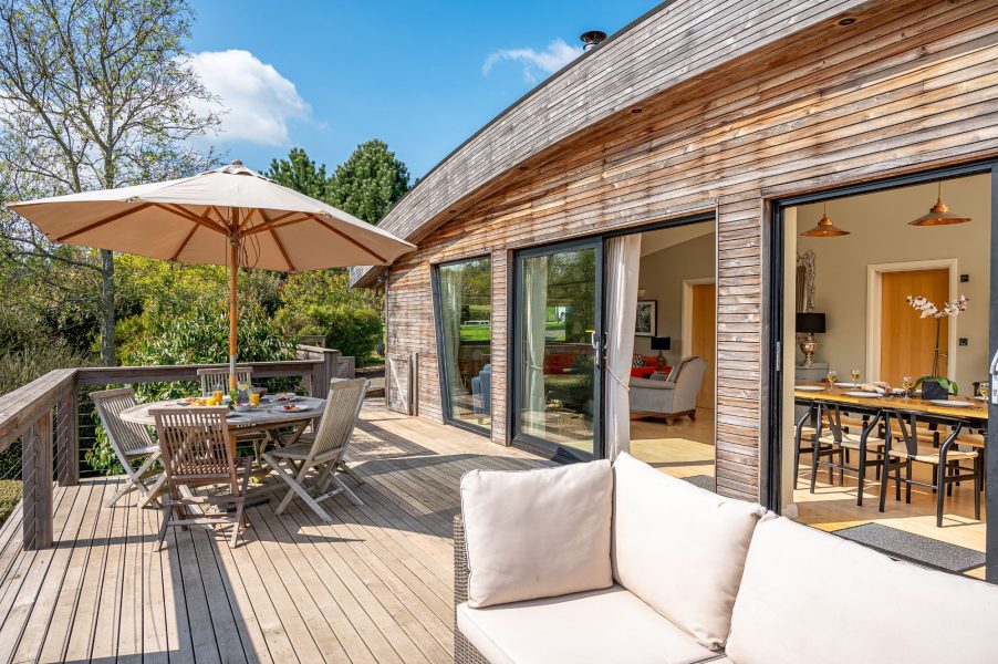 Private decking at Juniper Lodge in Brompton Lakes with outdoor seating and lake views.