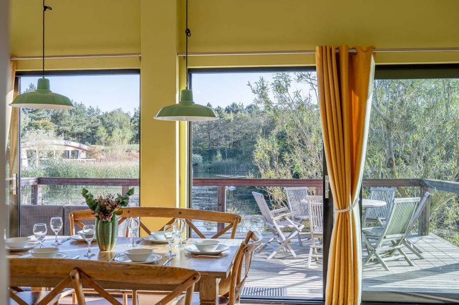 Dining area with lake views in Florence lodge at Brompton Lakes, Yorkshire.