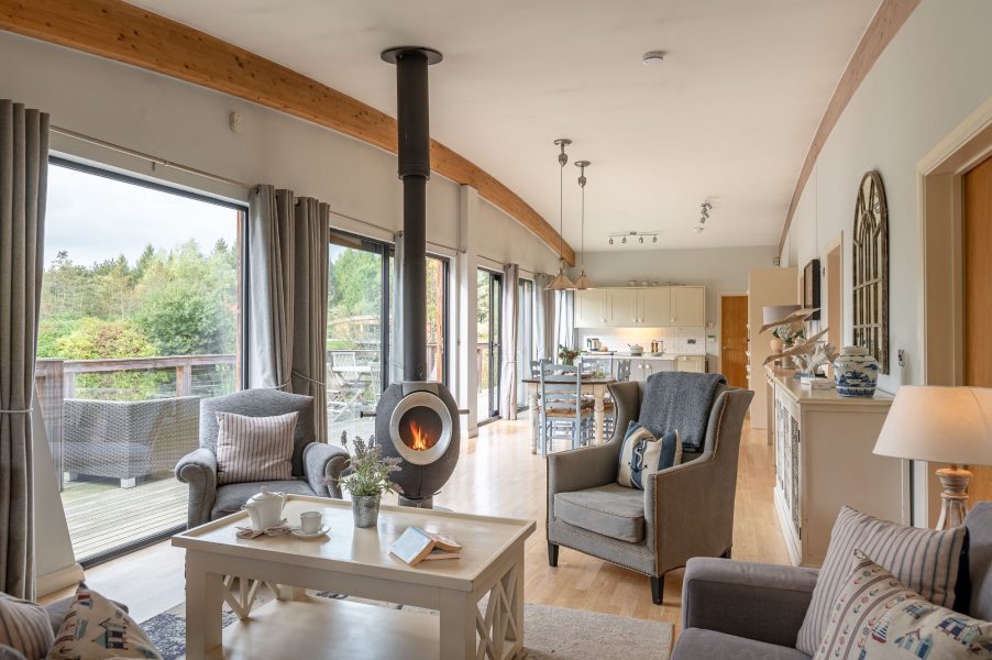 Open-plan lounge and kitchen with lake views in Iris Lodge at Brompton Lakes.