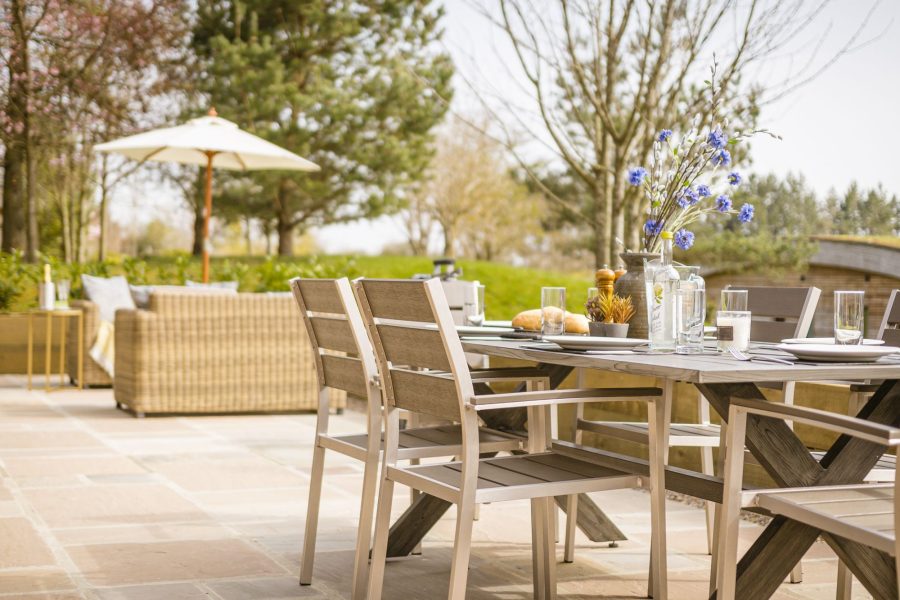 Outdoor decking with rattan sofas at Percy lodge, Brompton Lakes in Richmond, Yorkshire.