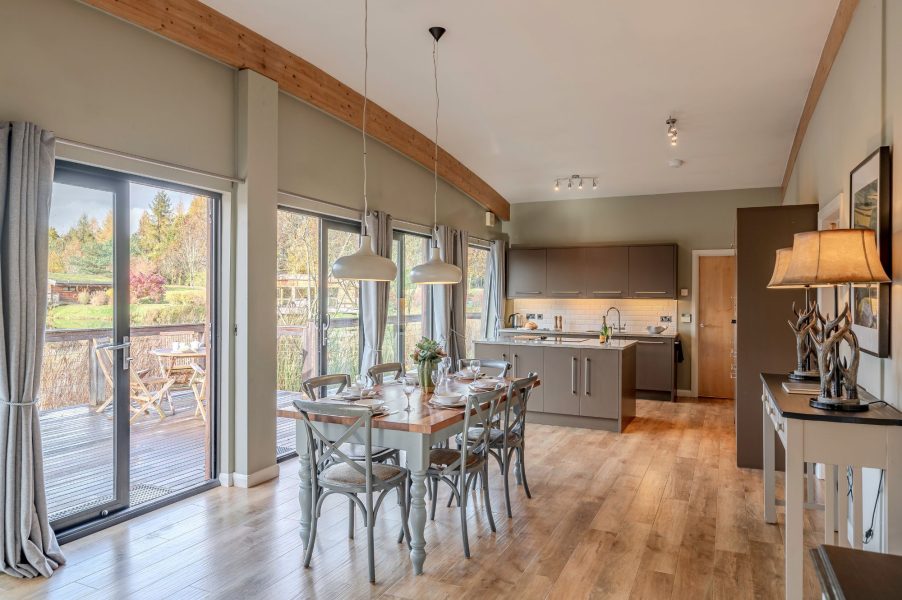 Modern kitchen and dining space with lakeside views in Rebecca lodge at Brompton Lakes.