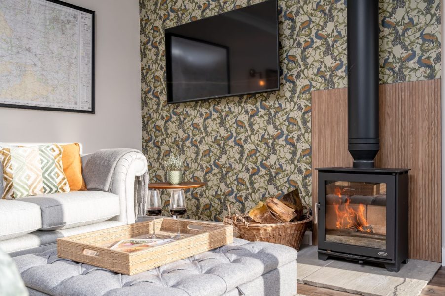 Cosy living room in The Stables, North Yorkshire with log burner, sofa and countryside cottage interior.
