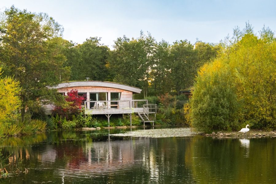 Isabella is set beside the lake with a private deck overlooking the water and surrounded by trees.