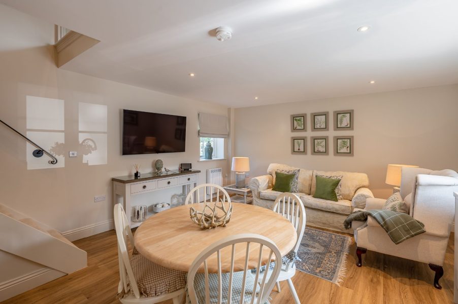Open-plan living and dining area with cosy seating at Feathered Nest accommodation