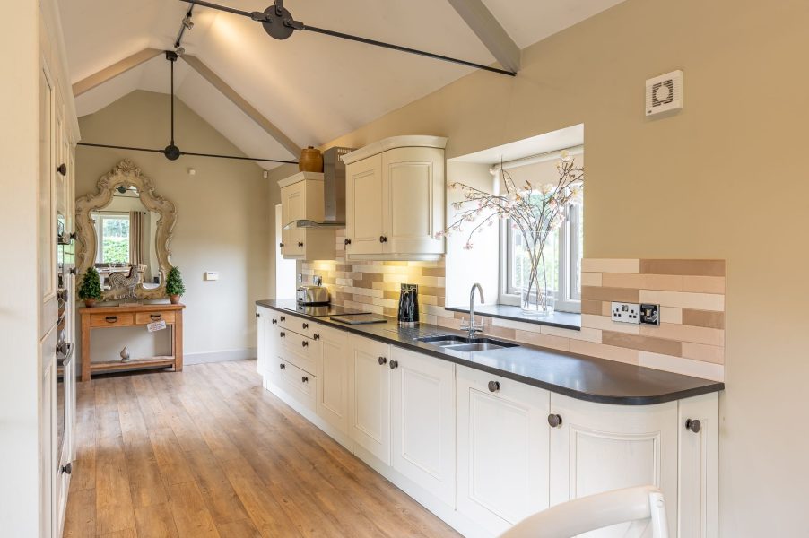 Modern and bright kitchen with garden views and vaulted ceiling in Austin holiday cottage.