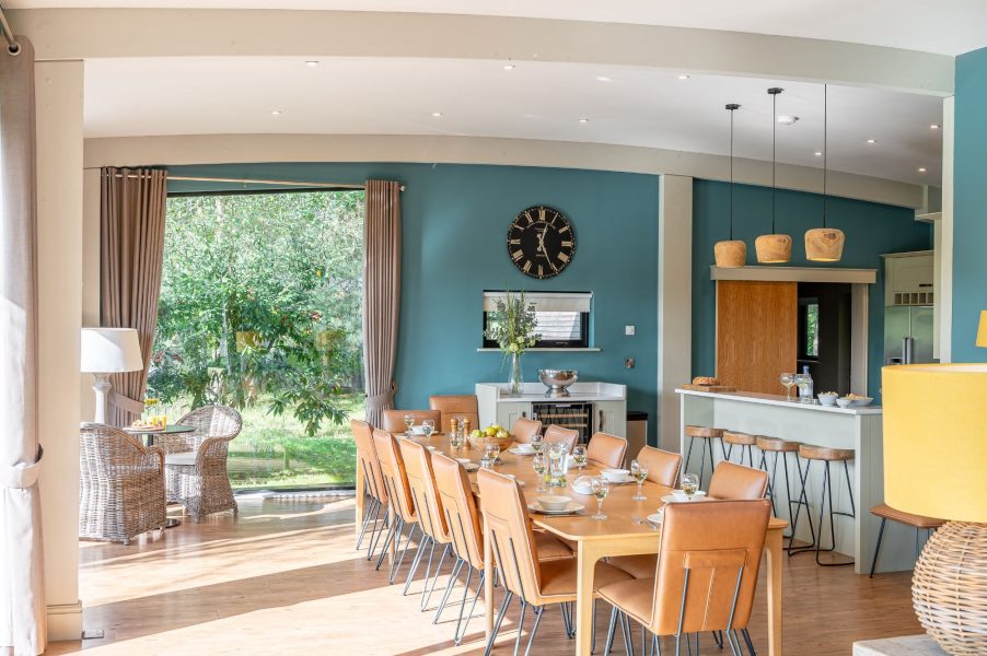 Spacious dining area with modern kitchen and breakfast bar at Twenty One lodge at Brompton Lakes.
