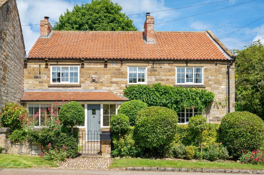 Exterior view of Paddock View in Osmotherley showing traditional stone cottage and garden.
