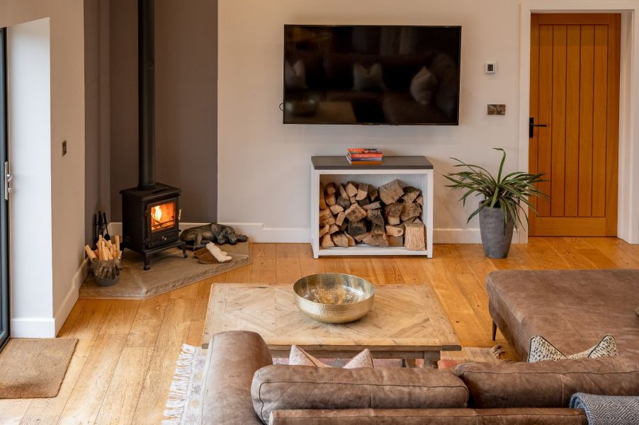 Cosy lounge with log burner, smart TV and comfortable seating in Millfield Barn.
