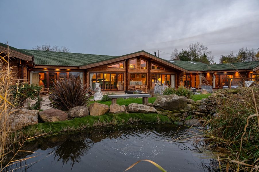 Exterior of Valley View lodge with patio seating area and large glass doors.