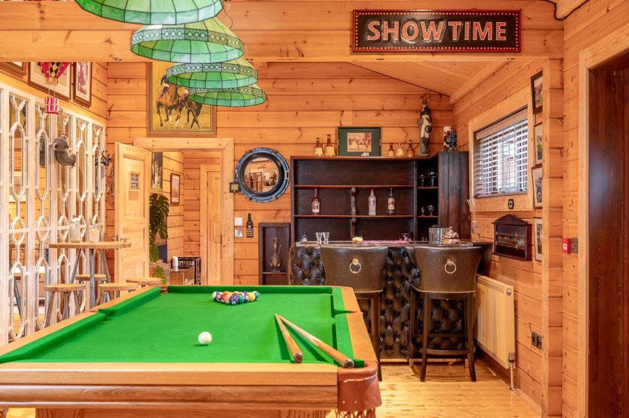 Games room at Valley View with full-size pool table, bar area and wooden interiors.