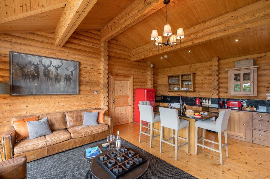 Kitchen and dining area in Constable Burton lodge with wooden cabinets, modern appliances and traditional log cabin interiors.