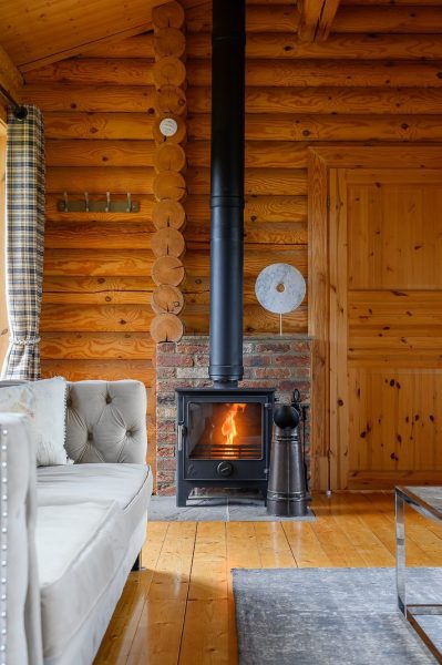 Log burner and sofa in Rosina lodge at Sun Hill Lodges.