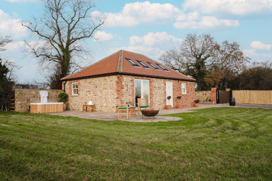 Exterior of Whitwell Nook holiday cottage in North Yorkshire with private hot tub, stone exterior and countryside views.