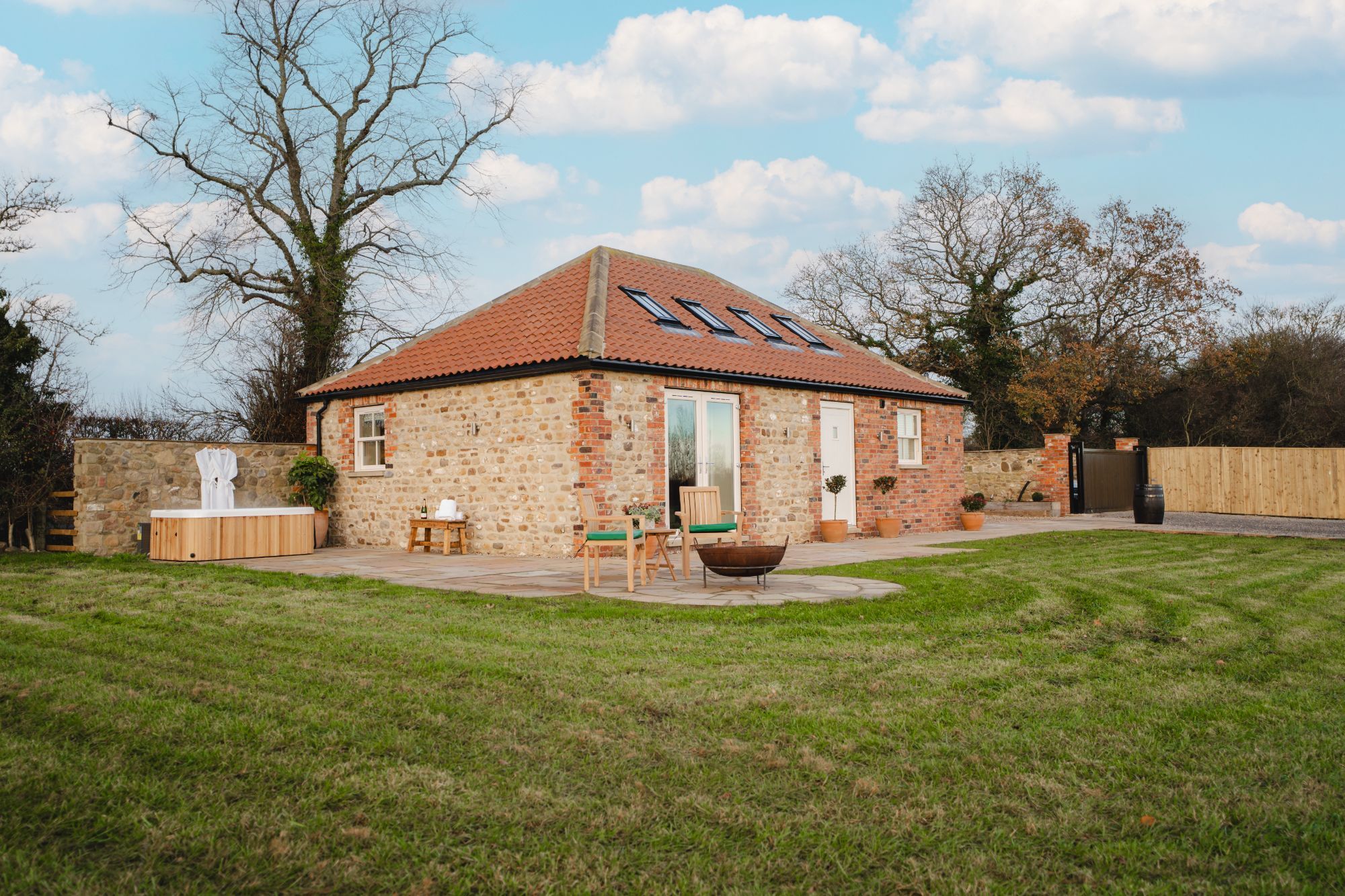 Exterior of Whitwell Nook holiday cottage in North Yorkshire with private hot tub, stone exterior and countryside views.