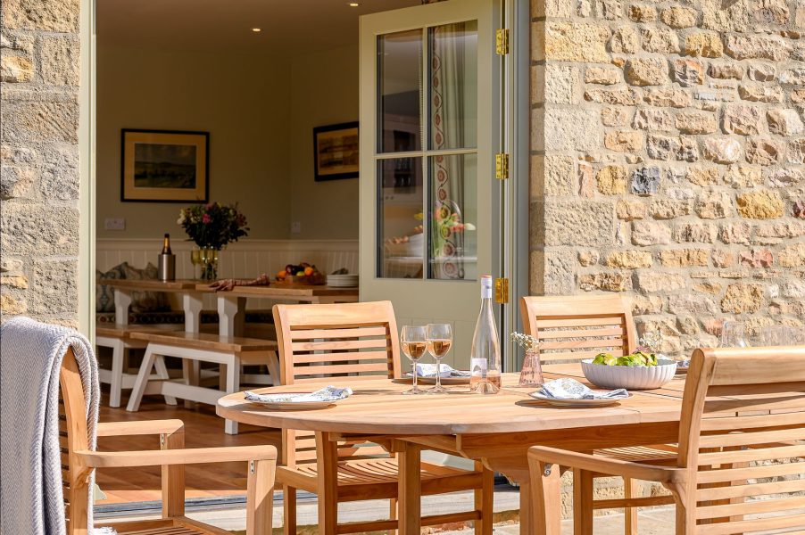Outdoor dining table from the kitchen at Hollins Barn with private terrace.
