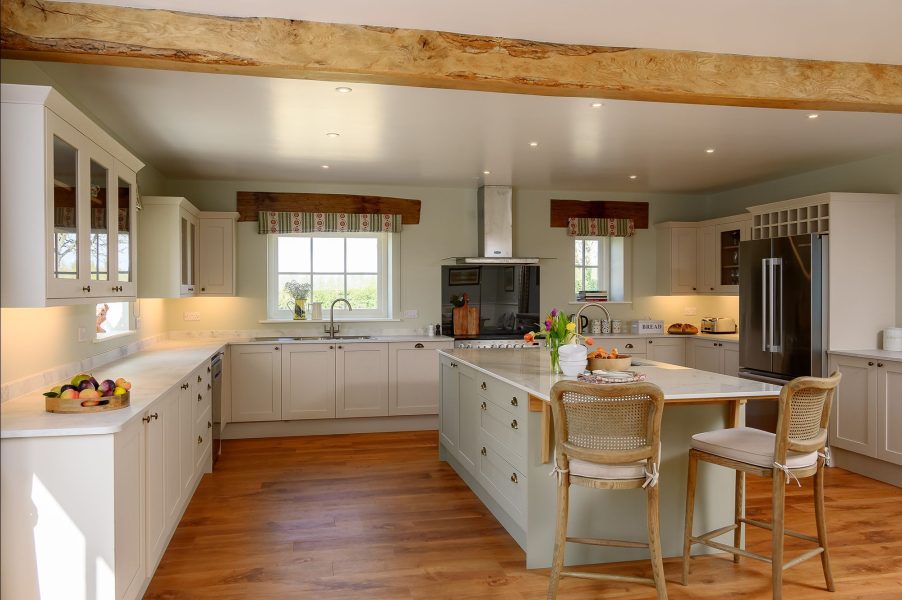 Large farmhouse kitchen in Hollins Barn with central island, modern appliances and countryside views.