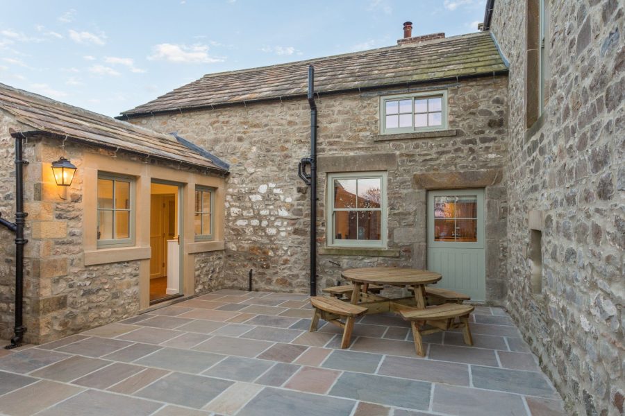 Courtyard at Hollins Farmhouse with seating.