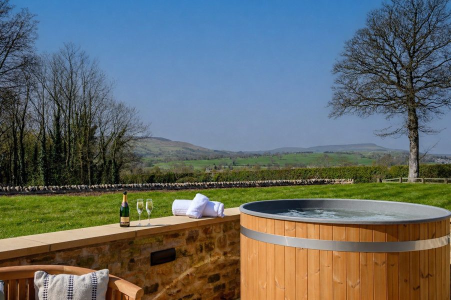 Luxury hot tub at Hollins Barn in North Yorkshire with countryside views and private terrace.