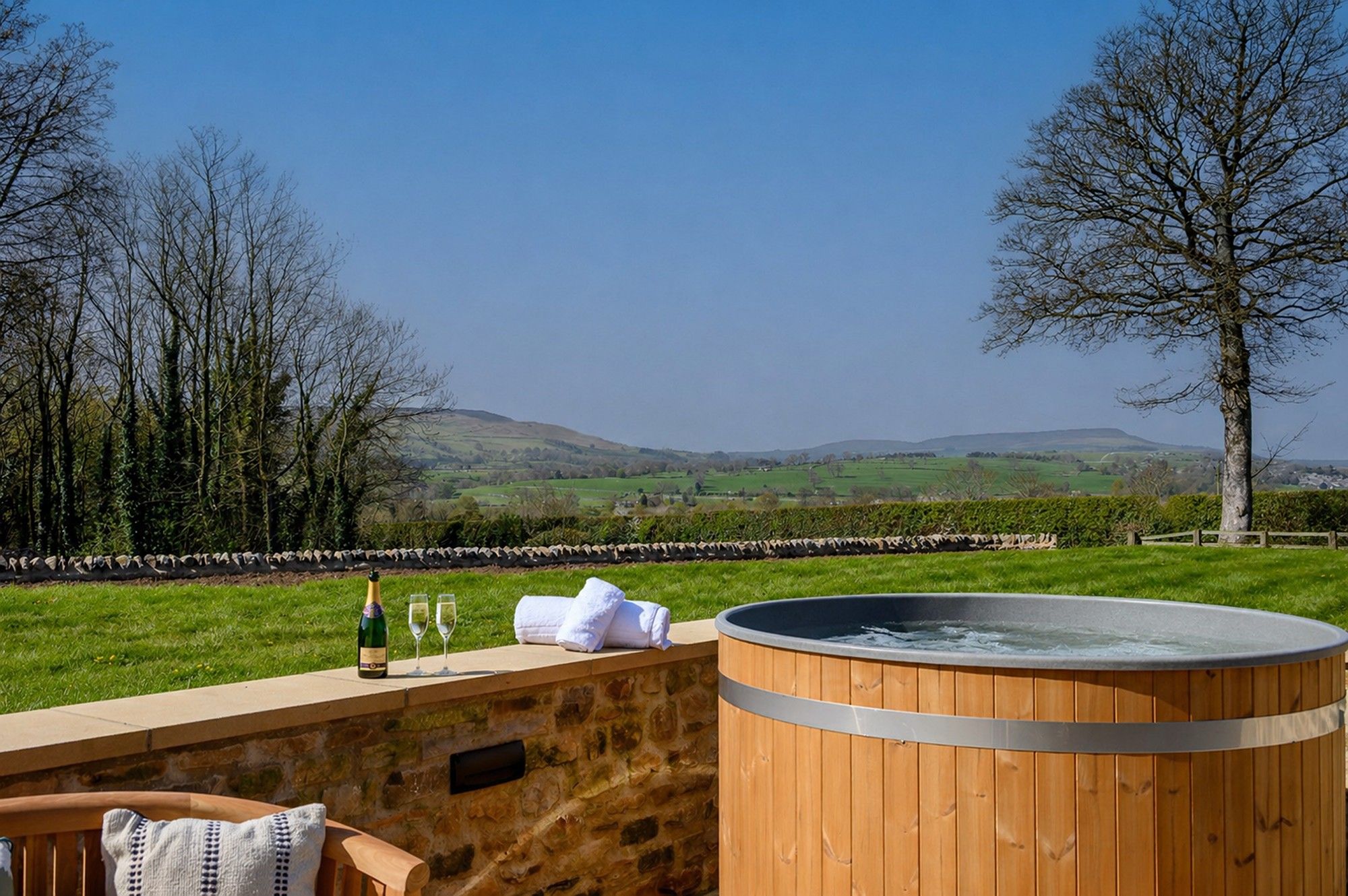 Luxury hot tub at Hollins Barn in North Yorkshire with countryside views and private terrace.