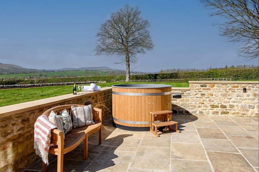 Luxury hot tub at Hollins Barn in North Yorkshire with countryside views and private terrace.
