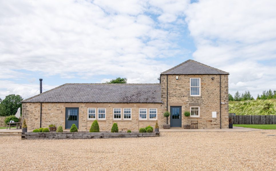 Charming stone exterior of Dexter with ample parking and peaceful rural surroundings perfect for a relaxing getaway