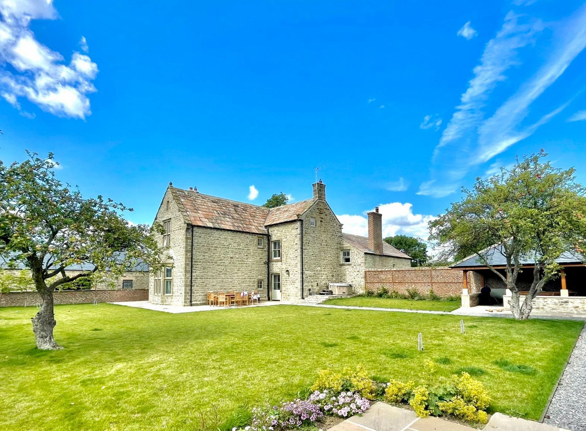 Exterior of Hollins Farmhouse, a large holiday home with large private garden in North Yorkshire.