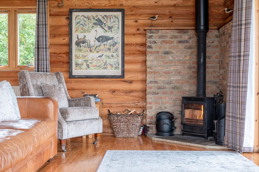 Cosy log burner in Lillie lodge with log cabin interiors.