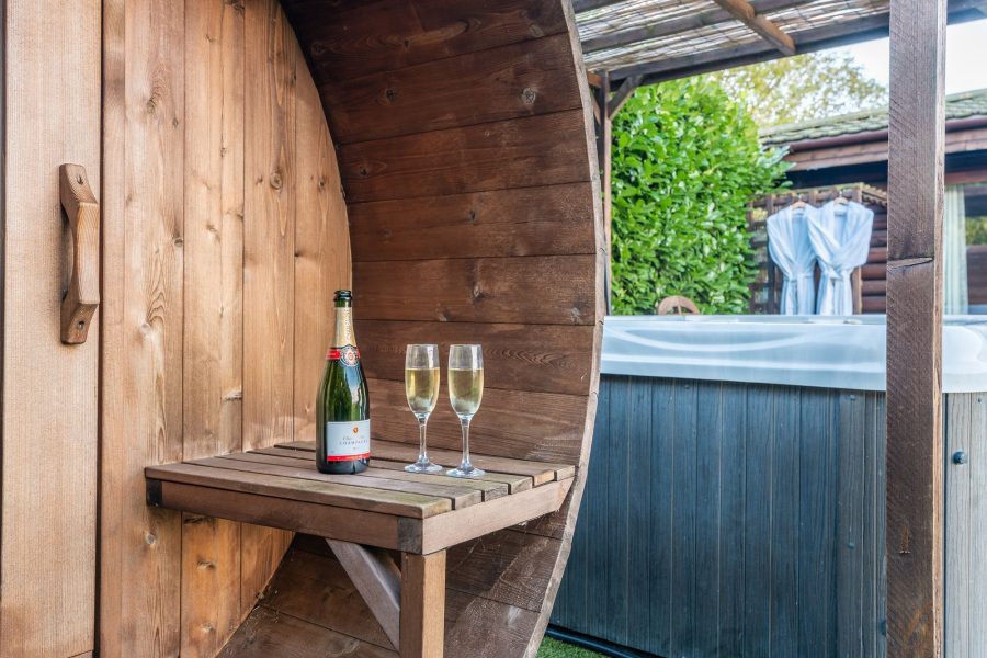 Barrel sauna and covered hot tub in private garden at William lodge.