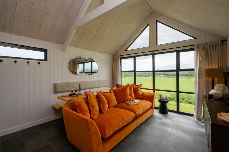 Modern open-plan kitchen and living area in Olof lodge in North Yorkshire with contemporary interiors and countryside views.