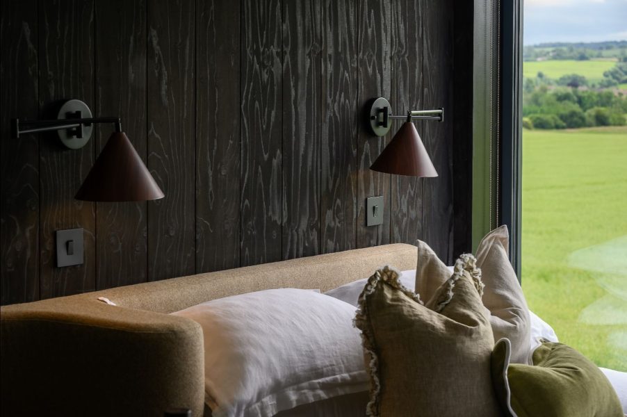 Scandinavian-style bedroom with natural textures and countryside view