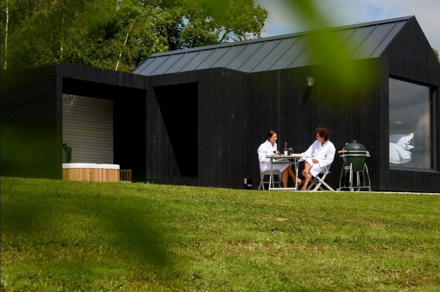 Couple sitting outside of Ari at Greenbank Lodges looking at the view. 