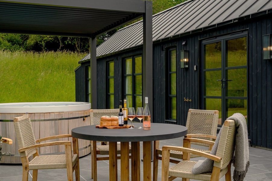 Exterior of Ake Lodge with private patio, hot tub, barbecue and scenic North Yorkshire countryside surroundings.