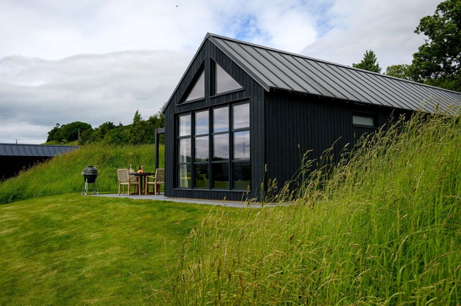 Black wood cabin in North Yorkshire, with countryside views and a hot tub. 
