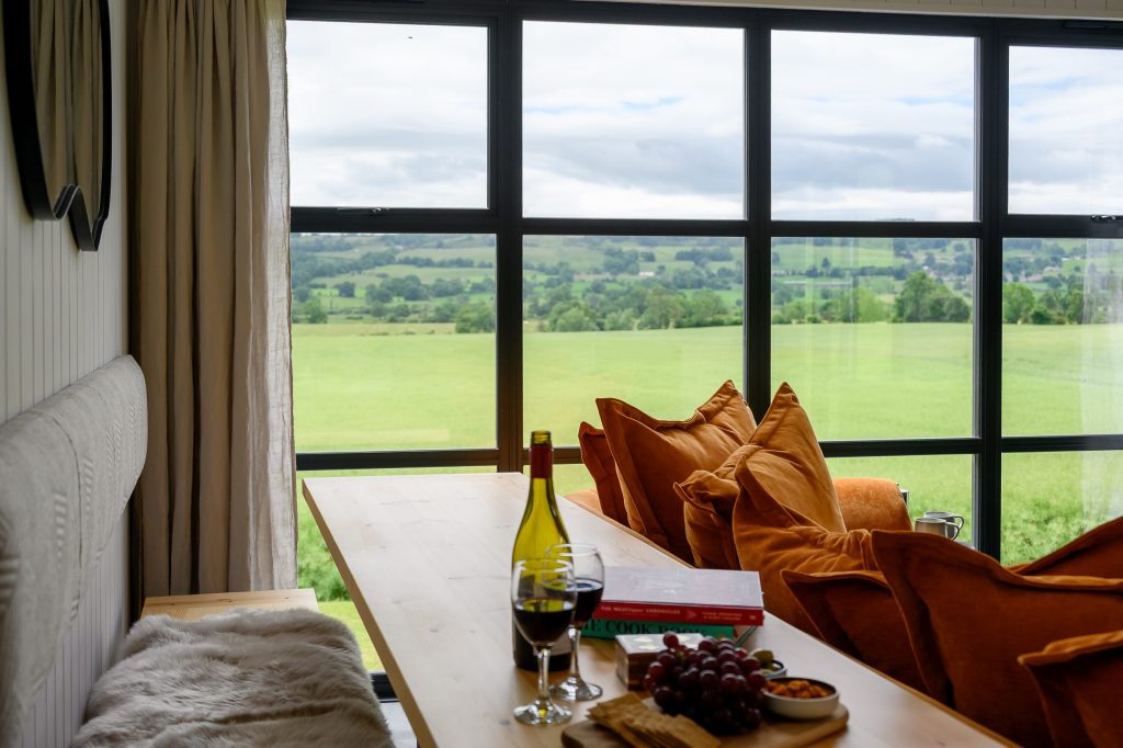 Lounge with seating area and food overlooking the countryside at Greenbank Lodges