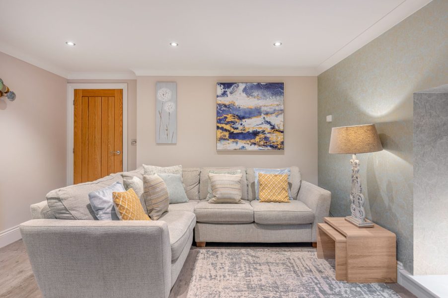 Cozy lounge with corner sofa and contemporary artwork at Darcy Mews property