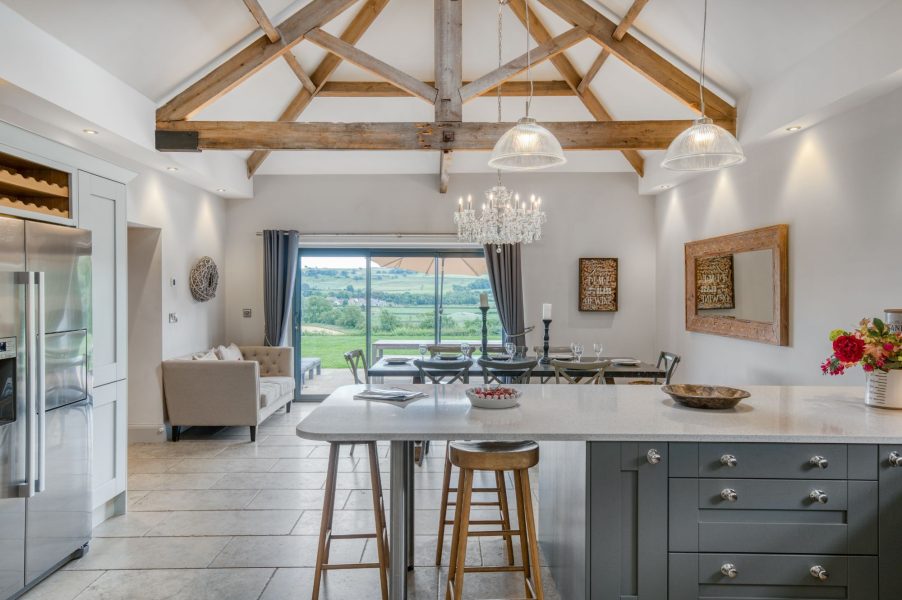Shorthorn open-plan kitchen, dining and living space with vaulted beams and countryside views