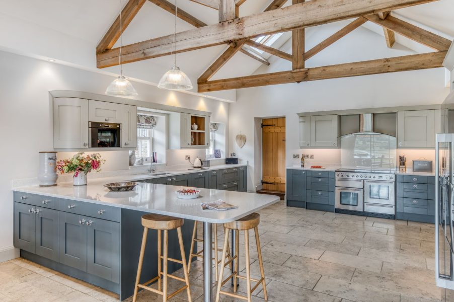 Shorthorn luxury farmhouse kitchen with large island, range cooker and exposed timber beams
