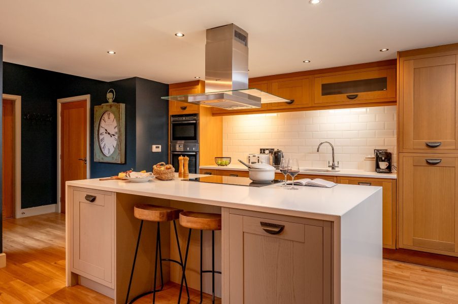 Modern open-plan kitchen with island, breakfast bar and integrated appliances in Georgia.