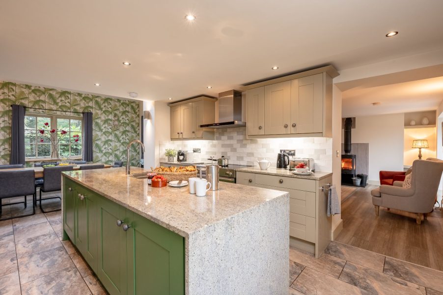 Modern country kitchen with large island and open plan living area in Henry cottage.