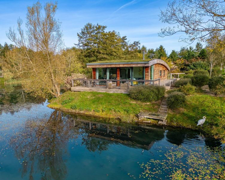 Exterior of Jasper lodge set in peaceful woodland by the lakes at Brompton Lakes, Yorkshire.