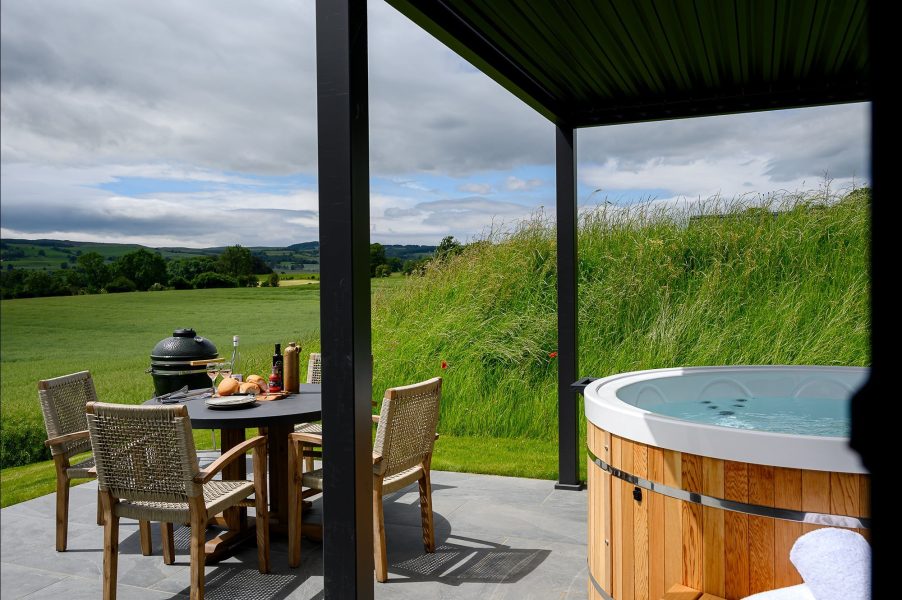 Luxury outdoor seating area and hot tub at Freyja lodge with private terrace space in the North Yorkshire countryside.