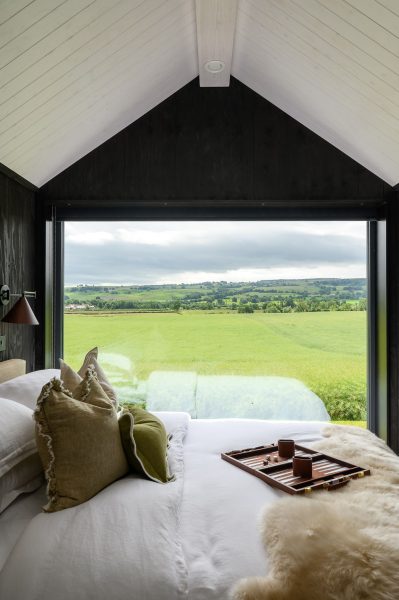 Bed positioned beneath Ari's large window overlooking North Yorkshire countryside.