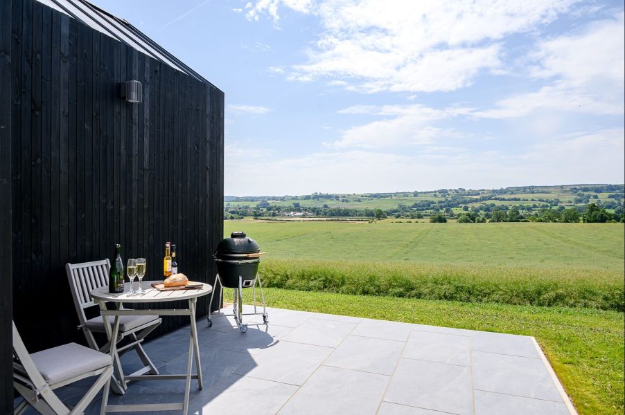 A private terrace with a view of the Yorkshire countryside at a luxury hot tub lodge