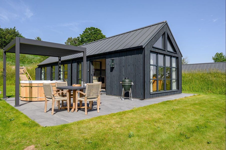 Black wood cabin in North Yorkshire, with countryside views and a hot tub.