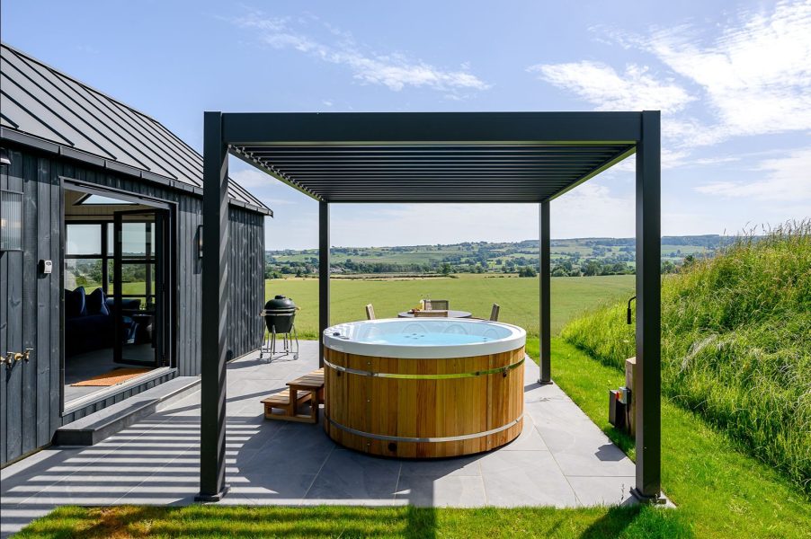 Luxury outdoor seating area and hot tub at Freyja lodge with private terrace space in the North Yorkshire countryside.