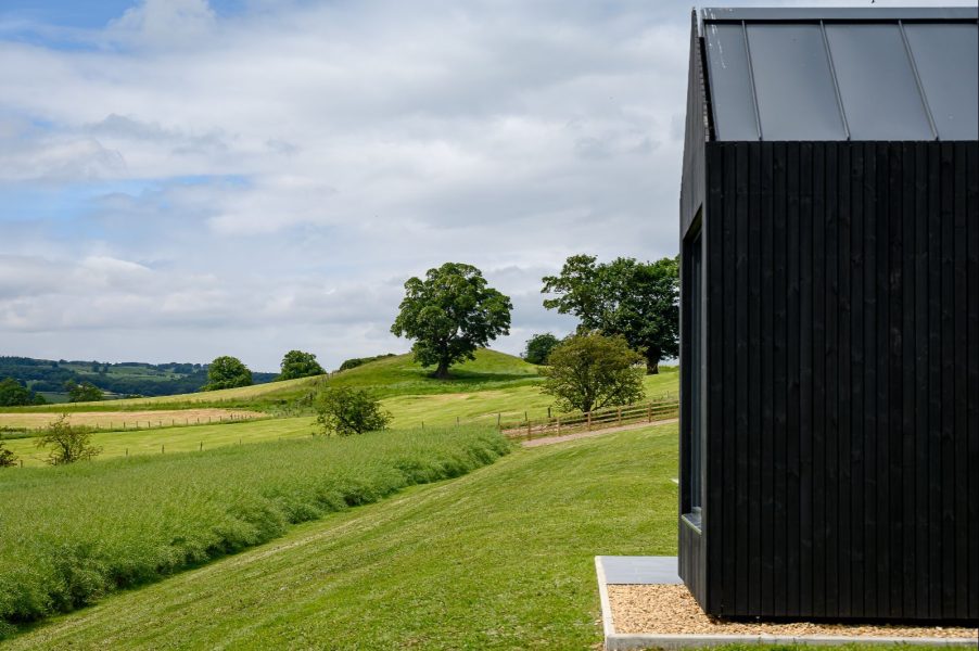 Fear reaching views of black wood cabins in yorkshire countryside.  