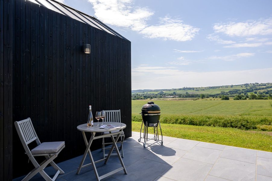 Private patio with outdoor seating and countryside views at Von lodge in North Yorkshire.