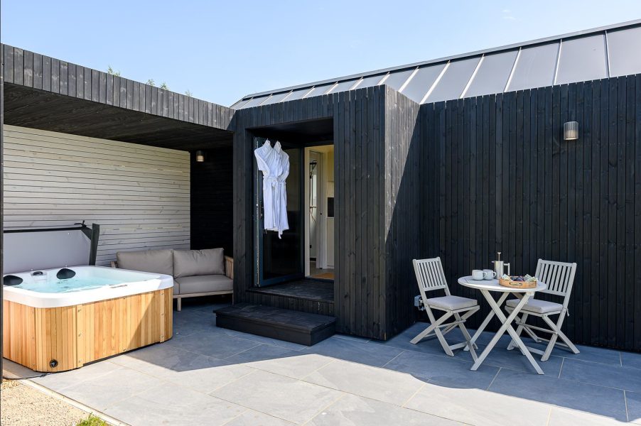 Private hot tub on the covered terrace of Elvar, a luxury lodge at Greenbank Lodges.