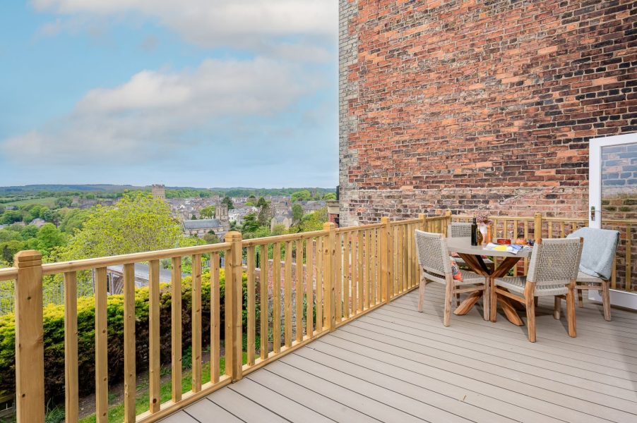Private balcony at Maison Cottage with outdoor seating and far-reaching views of the River Swale and Richmond in Yorkshire.